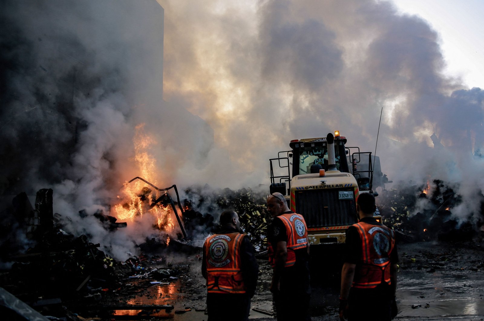 Smoke and fire rise from buildings as rescuers gather amid the destruction in the aftermath of an Israeli strike on Gaza City, Palestine, Oct. 26, 2023. (AFP Photo)