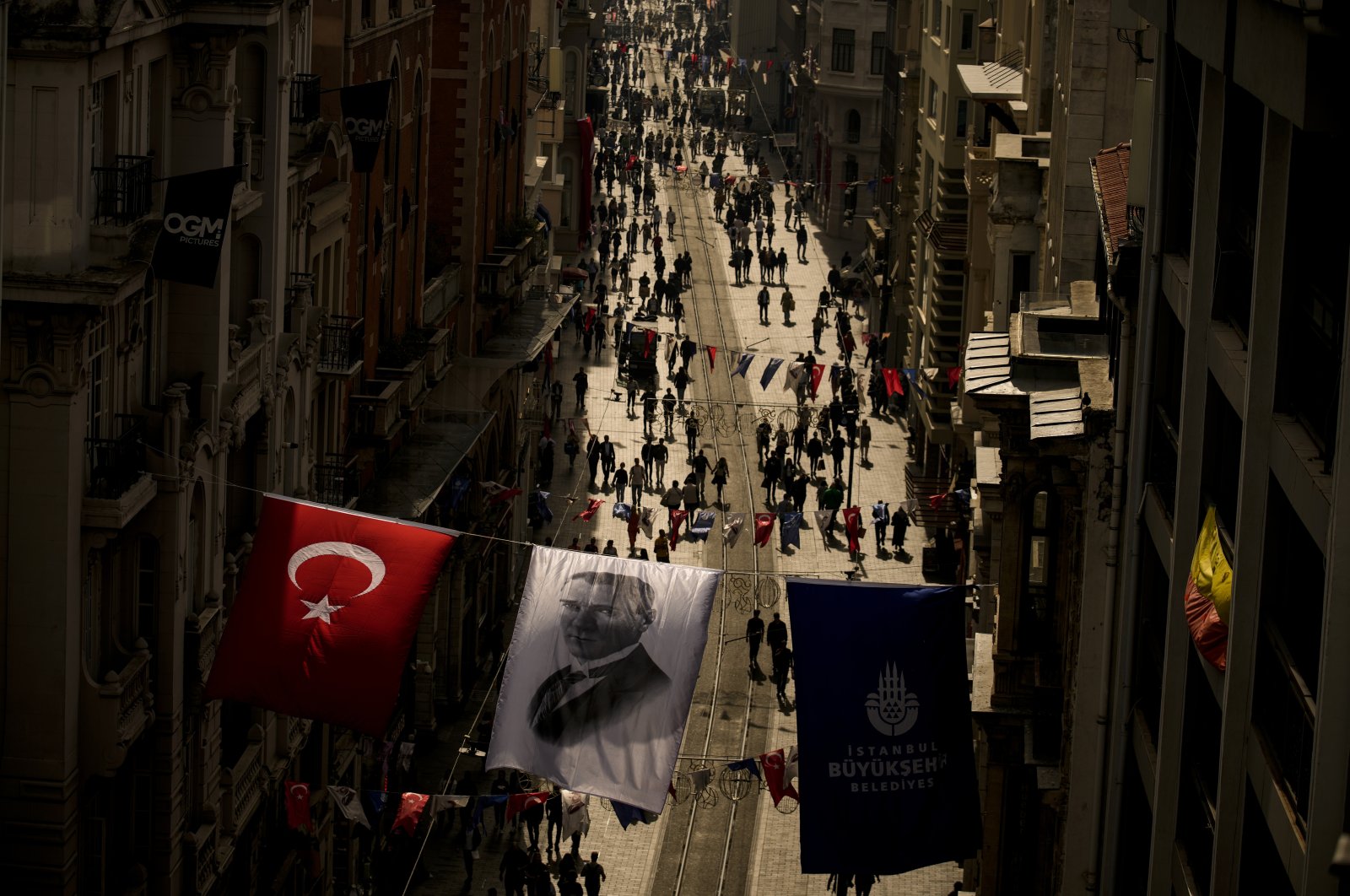 An image of Mustafa Kemal Ataturk, hangs next to a national flag over Istiklal Street, in Istanbul, Türkiye, Oct. 25, 2023. (AP Photo)