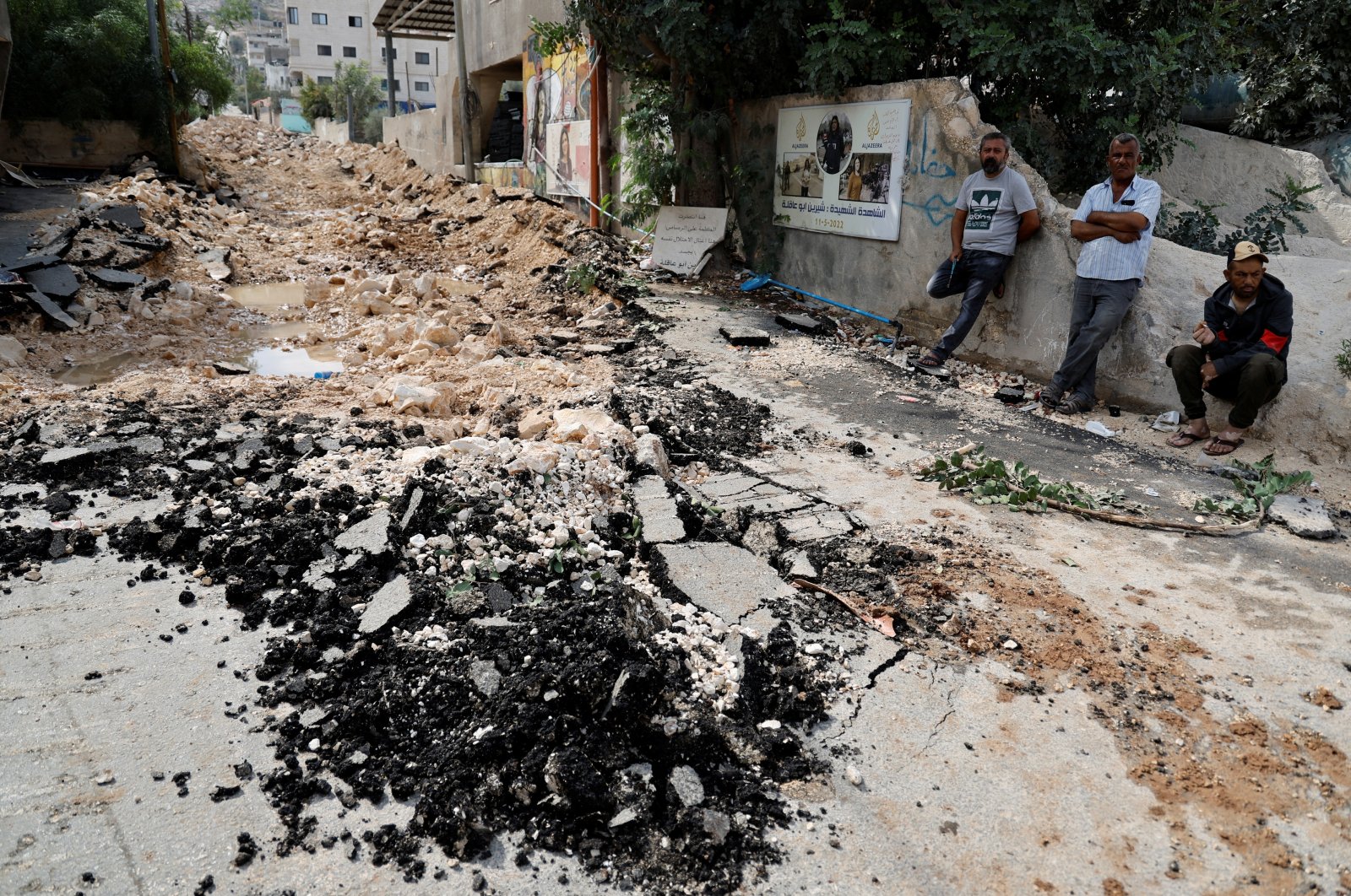 Palestinians stand on the destroyed Shireen Abu Akleh street, following an Israeli raid, in Jenin Camp, in the Israeli-occupied West Bank, Oct.27, 2023. (Reuters Photo)