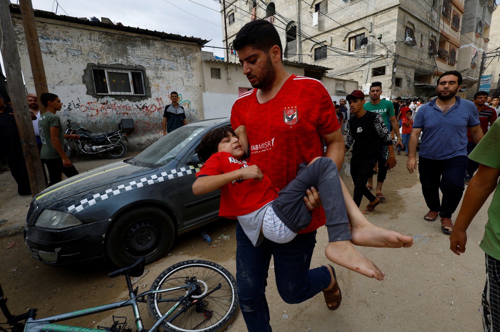 A man carries a child at the site of an Israeli air strike on a house, in Khan Younis in the southern Gaza Strip, Palestine, Oct. 27, 2023. (Reuters Photo)