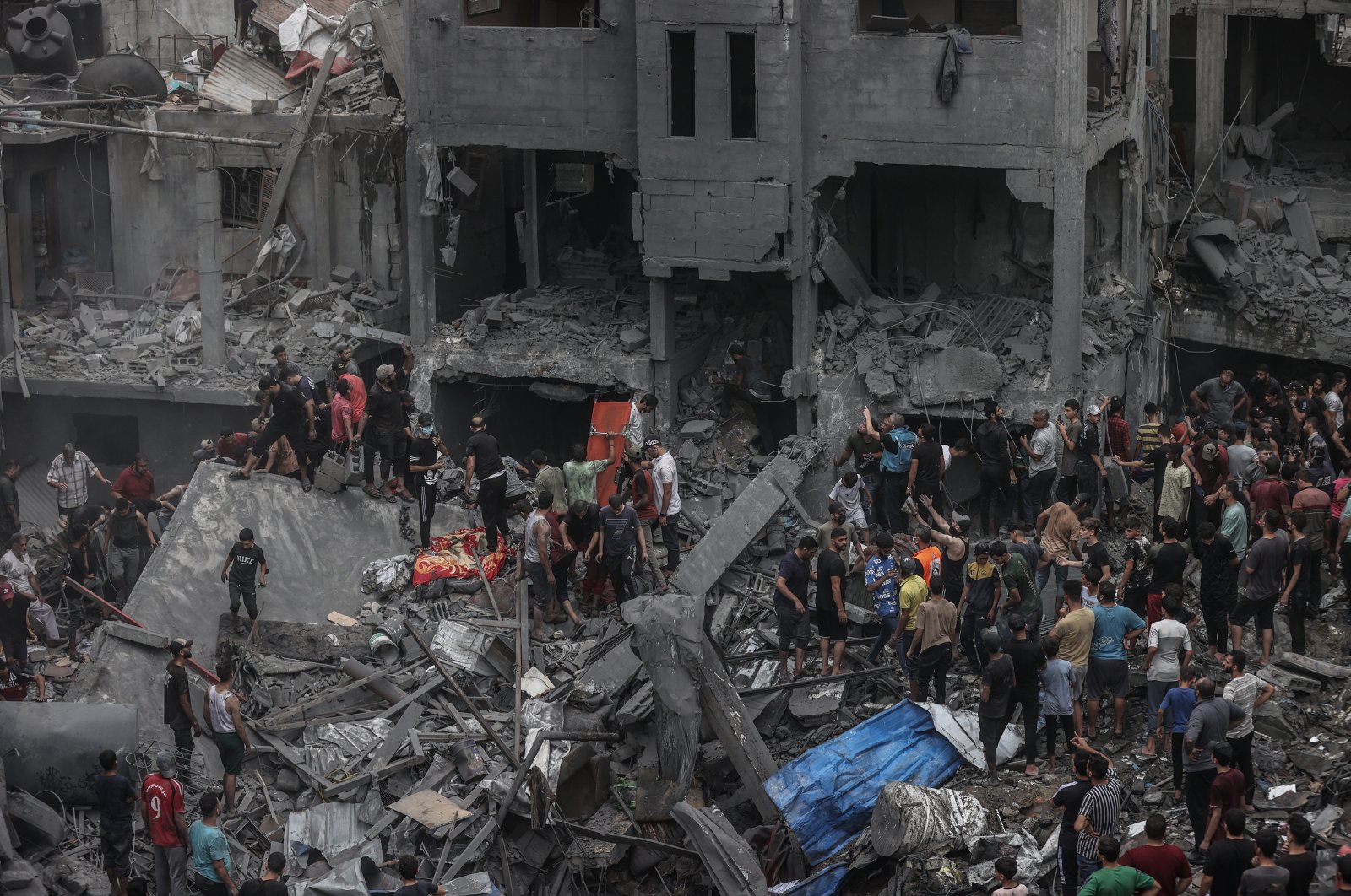 Rescue teams seen working to save civilians from under the rubble at a site hit by Israeli airstrikes, Gaza Strip, Palestine, Oct. 27, 2023. (AA Photo)