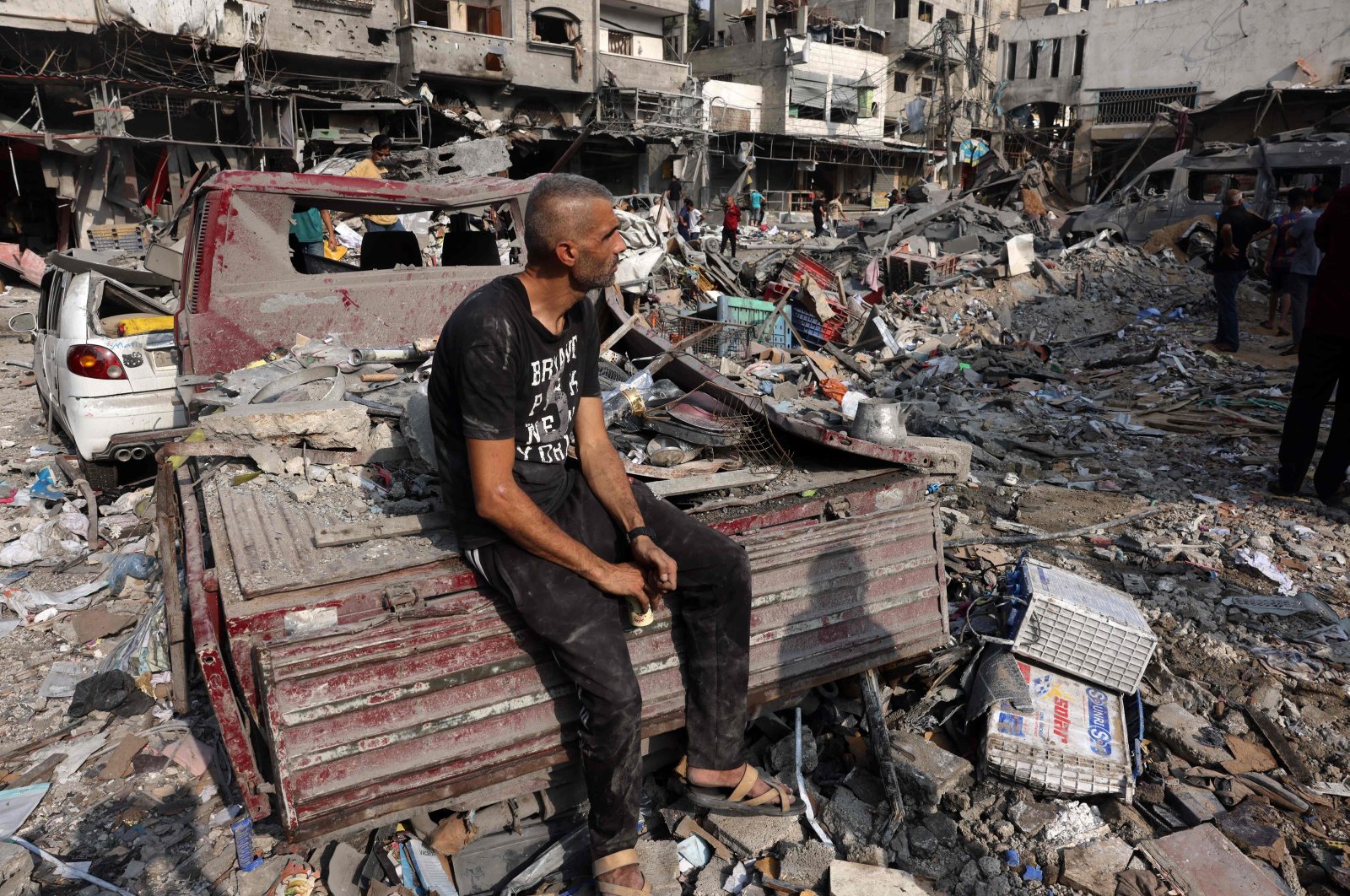 A man sits amid the destruction following Israeli strikes on Al-Shatee camp in Gaza City, Palestine, Oct. 28, 2023. (AFP Photo)