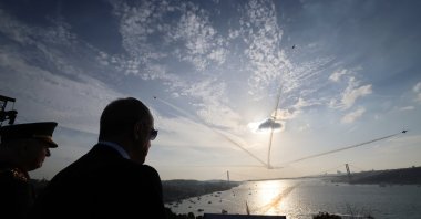 President Recep Tayyip Erdoğan watches Turkish jets performing stunts for Republic Day as Turkish warships passes by Bosporus below, in Istanbul, Türkiye, October 29, 2023. (DHA Photo) 