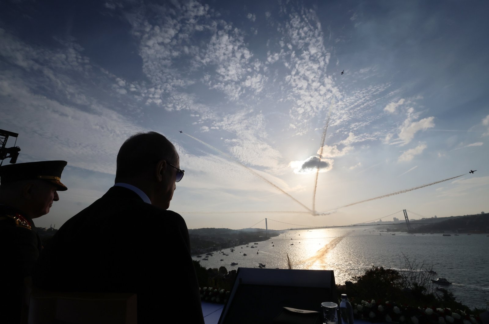 President Recep Tayyip Erdoğan watches Turkish jets performing stunts for Republic Day as Turkish warships passes by Bosporus below, in Istanbul, Türkiye, October 29, 2023. (DHA Photo) 