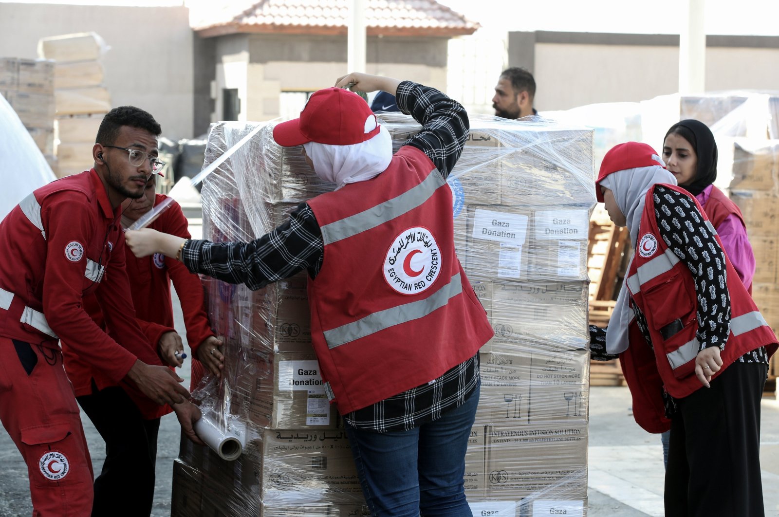 Egyptian Red Crescent Society employees and volunteers handle humanitarian aid bound for Palestinians in the Gaza Strip, at a warehouse in Arish, Egypt, Oct. 25, 2023. (EPA Photo)