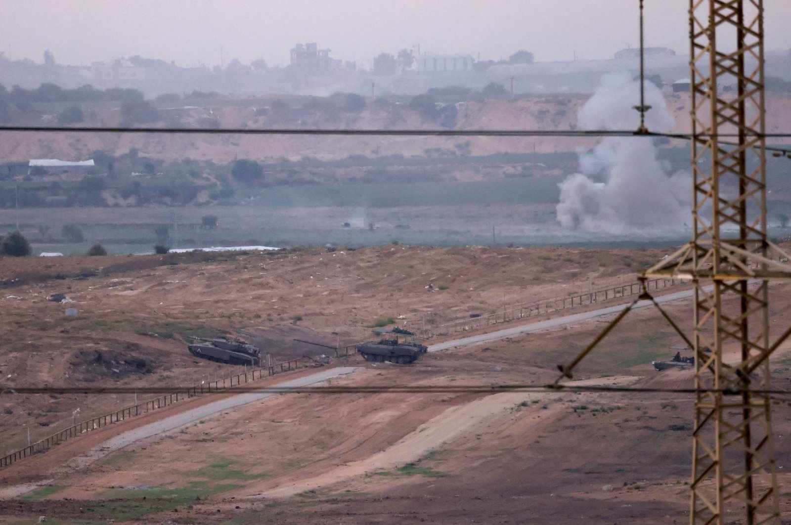 A picture taken from southern Israel along the border with the Gaza Strip shows Israeli army tanks and bulldozers crossing the border into Gaza, Palestine, Oct. 29, 2023. (AFP Photo)