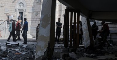 People stand near the rubble at the Greek Orthodox Saint Porphyrius Church following an overnight Israeli airstrike in Gaza, Oct. 20, 2023. (EPA Photo)