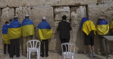 Ukrainian delegation from Kyiv wrapped in Ukrainian flags pray at the Western Wall, the holiest site where Jews can pray in Jerusalem&#039;s Old City, April 1, 2022. (AP Photo)