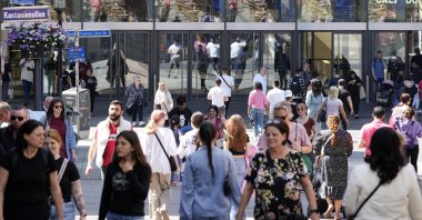 People walk on a shopping street in Essen, Germany, May 31, 2023. (AP Photo)