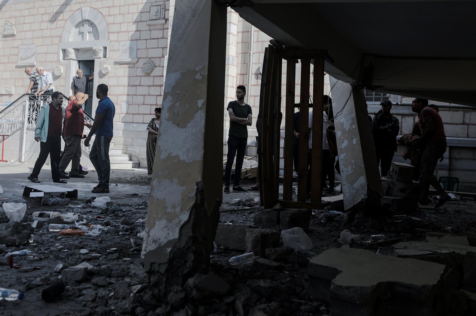 People stand near the rubble at the Greek Orthodox Saint Porphyrius Church following an overnight Israeli airstrike in Gaza, Oct. 20, 2023. (EPA Photo)