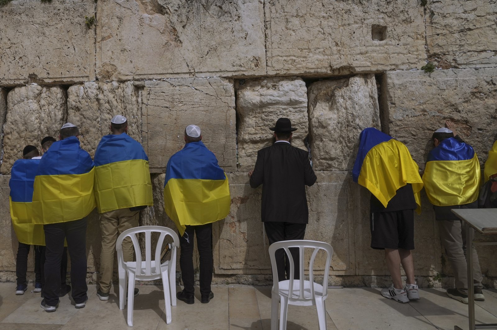 Ukrainian delegation from Kyiv wrapped in Ukrainian flags pray at the Western Wall, the holiest site where Jews can pray in Jerusalem&#039;s Old City, April 1, 2022. (AP Photo)