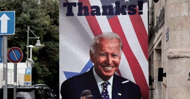 A man walks past a giant poster of U.S. President Joe Biden in a street of Jerusalem, Oct. 20, 2023. (AFP Photo)