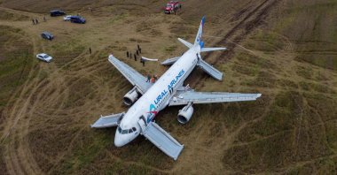 An Airbus A320 of Russia&#039;s Ural Airlines passenger plane, which made an emergency landing in a field while flying from Sochi to Omsk, is seen near the settlement of Kamenka in the Novosibirsk region, Russia, Sept. 12, 2023. (Reuters Photo)