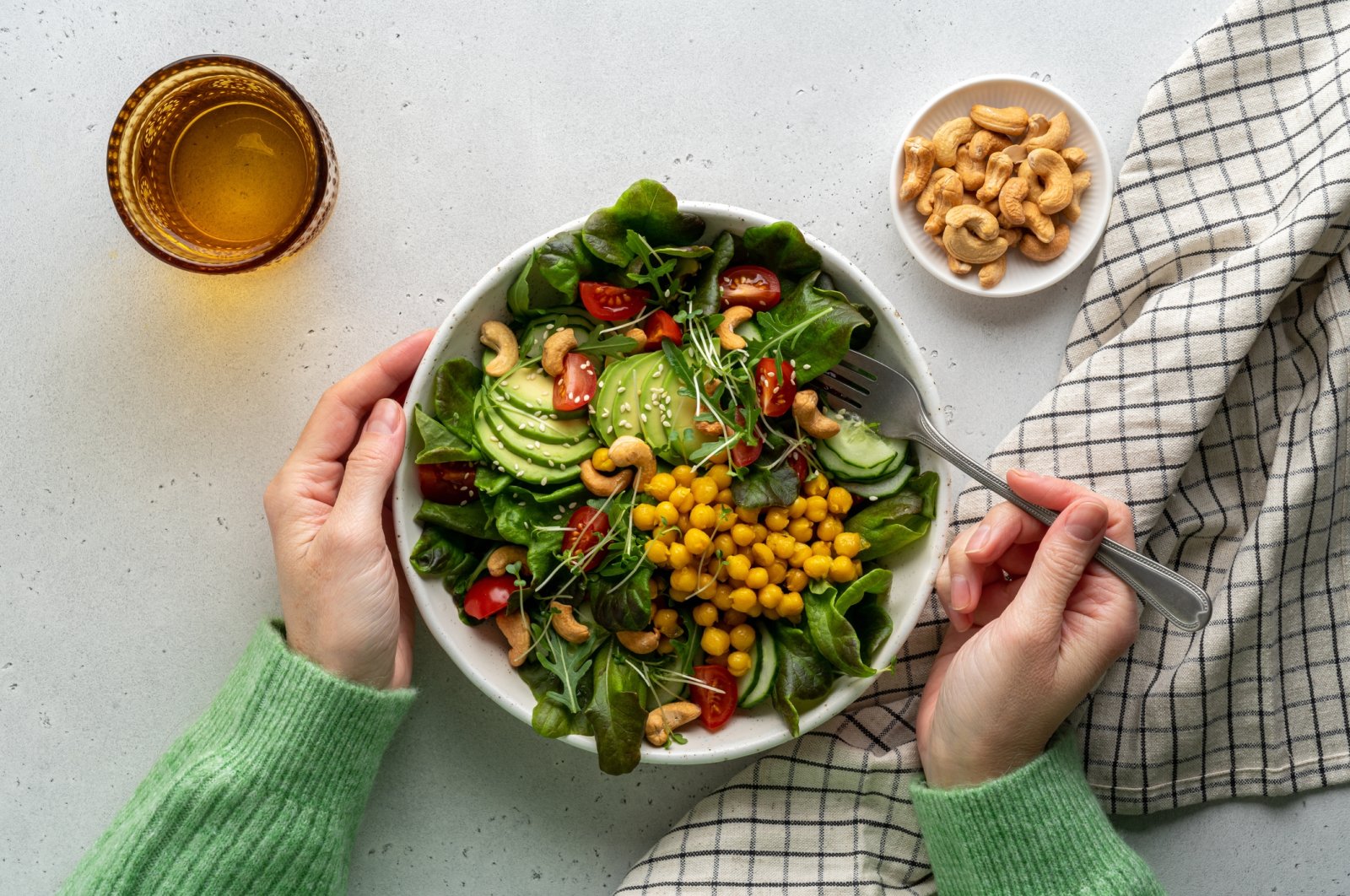 A vegan plant-based salad in a bowl with avocado, cashew, micro-greens, pok choi, chickpeas, tomato, lettuce, cucumber and sesame. (Getty Images Photo)