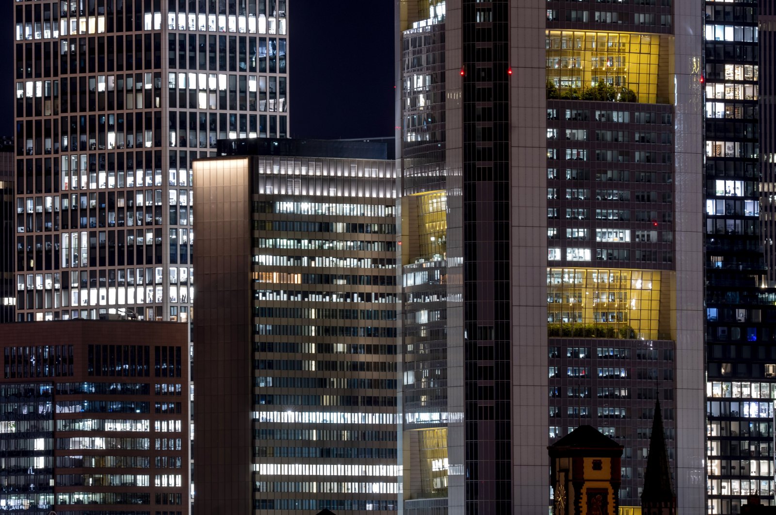 Lights shine in the offices of the bank buildings in Frankfurt, Germany, March 16, 2023. (AP Photo)