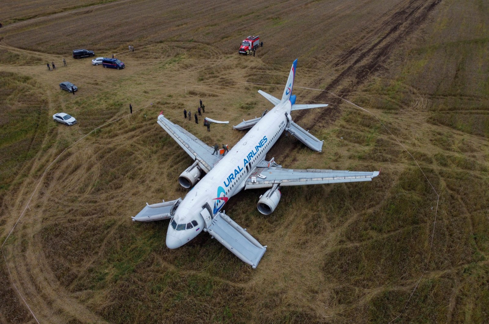 An Airbus A320 of Russia&#039;s Ural Airlines passenger plane, which made an emergency landing in a field while flying from Sochi to Omsk, is seen near the settlement of Kamenka in the Novosibirsk region, Russia, Sept. 12, 2023. (Reuters Photo)