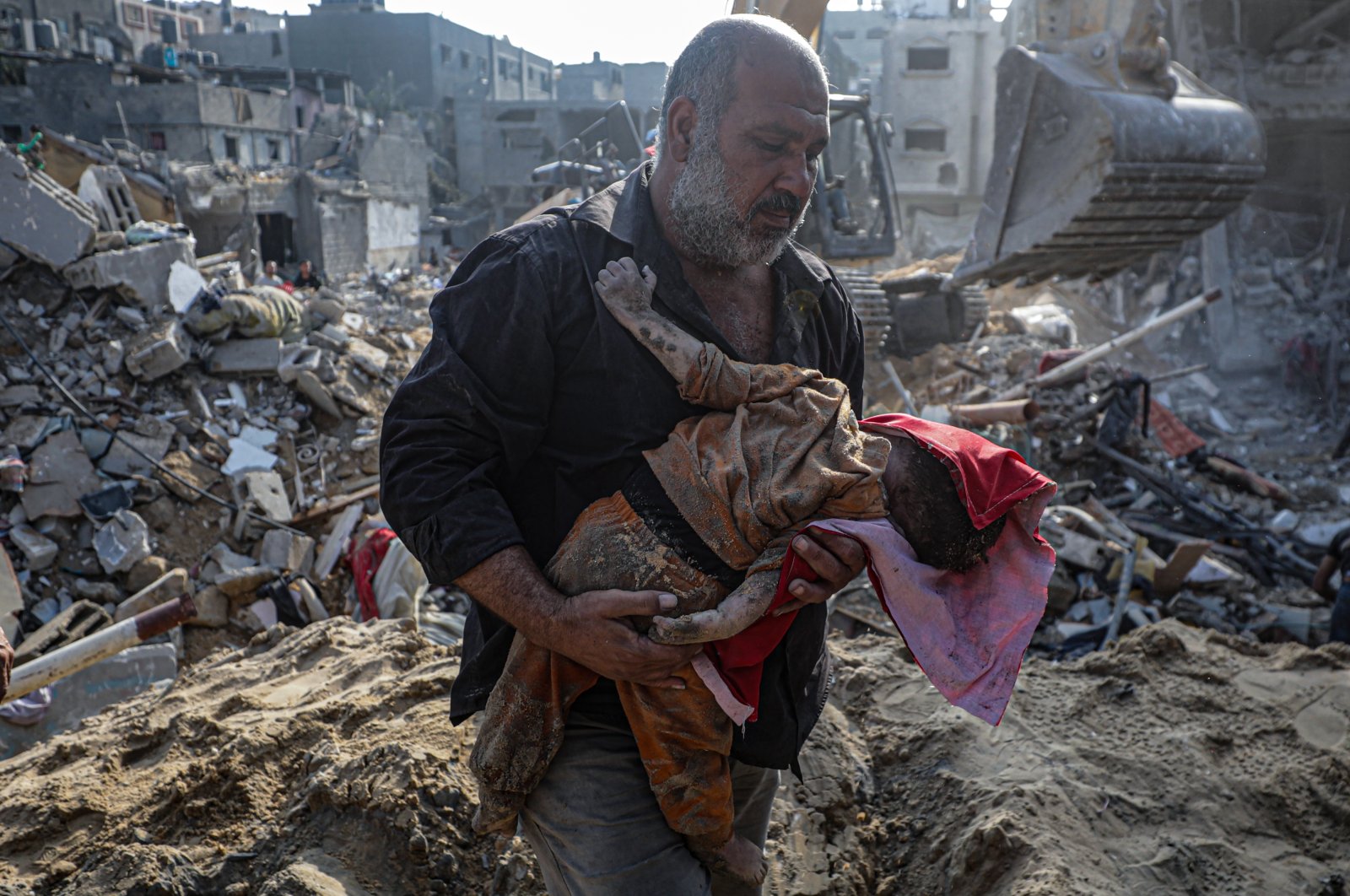 A Palestinian man carries the body of a baby recovered from the rubble of the Jabalia refugee camp, one day after an airstrike hit the area, in northern Gaza, Nov. 1, 2023. (EPA Photo)