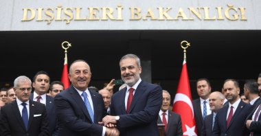 Foreign Minister Hakan Fidan (R), shakes hands with former Foreign Minister Mevlüt Çavuşoğlu (L), Ankara, Türkiye, June 5, 2023. (Getty Images Photo)