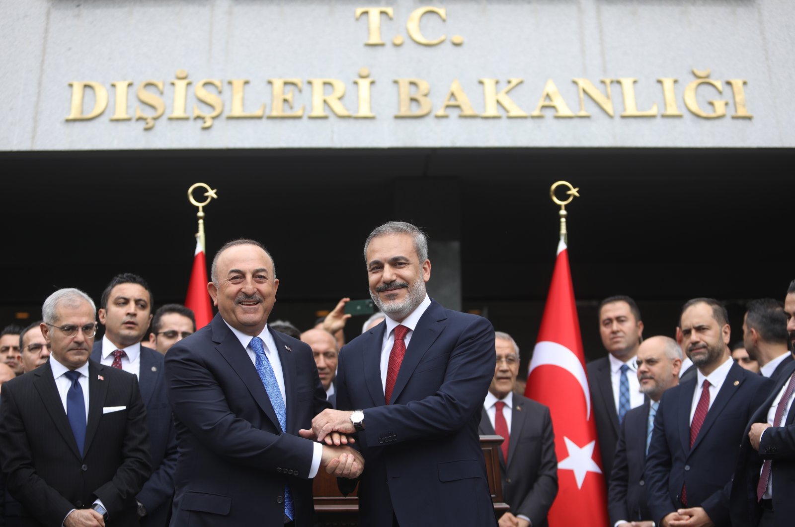 Foreign Minister Hakan Fidan (R), shakes hands with former Foreign Minister Mevlüt Çavuşoğlu (L), Ankara, Türkiye, June 5, 2023. (Getty Images Photo)