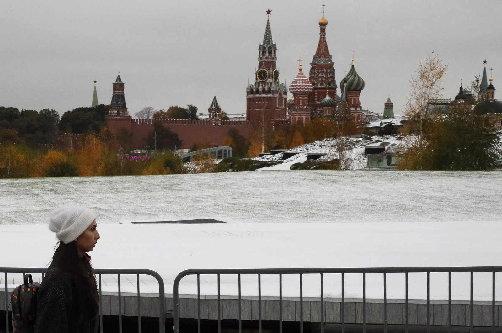 A woman walks along a snow-covered place in front of the Kremlin (background) after the first snowfall in Moscow, Russia, Oct. 27, 2023. (EPA Photo)