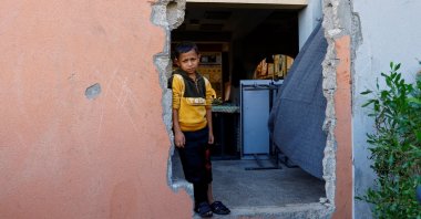A Palestinian boy looks out of a hole in the wall, at a school turned to a shelter, in Khan Younis, southern Gaza Strip, Palestine, Oct. 31, 2023. (Reuters Photo)
