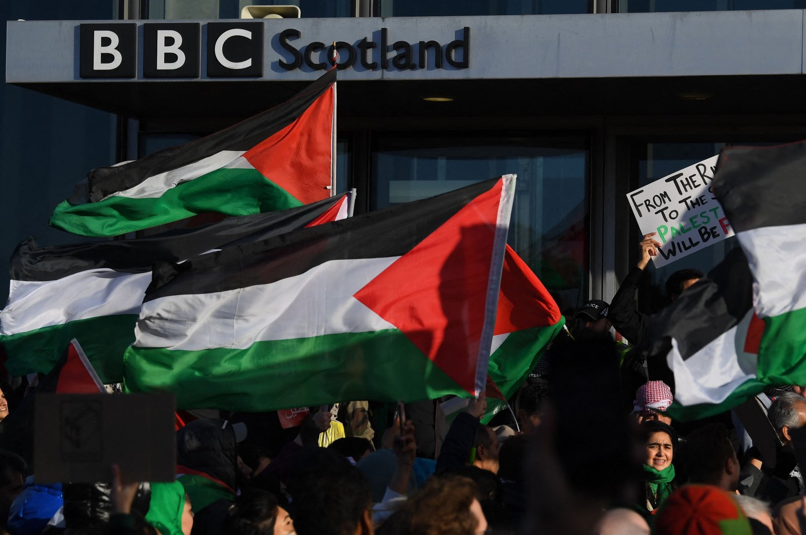 Palestinian flags are waved outside the BBC Scotland building as people take part in a demonstration to show solidarity with the Palestinian People, in Glasgow, Scotland, Oct. 14, 2023. (AFP Photo)