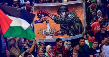 Demonstrators wave Palestinian flags and hold signs as they take part in a rally with slogan "Long live the Palestinian resistance. Genocidal Zionism", in support of the Palestinian people, in Bilbao, Spain, Oct. 28, 2023. (AFP Photo)