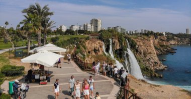 Tourists are seen walking close to the famous Düden Waterfalls, Antalya, southern Türkiye, Oct. 7, 2023. (IHA Photo)