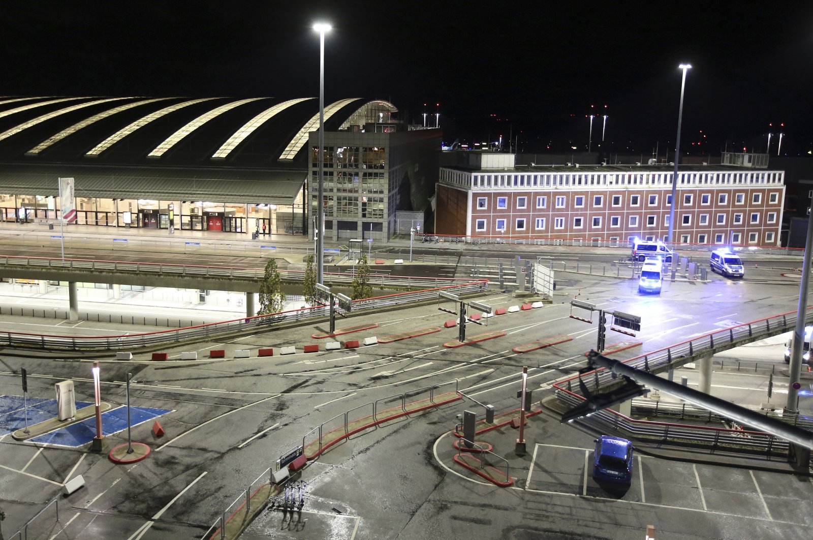 Police vehicles block access to Hamburg Airport during an operation, in Hamburg, Germany, Nov. 4, 2023. (AP Photo)