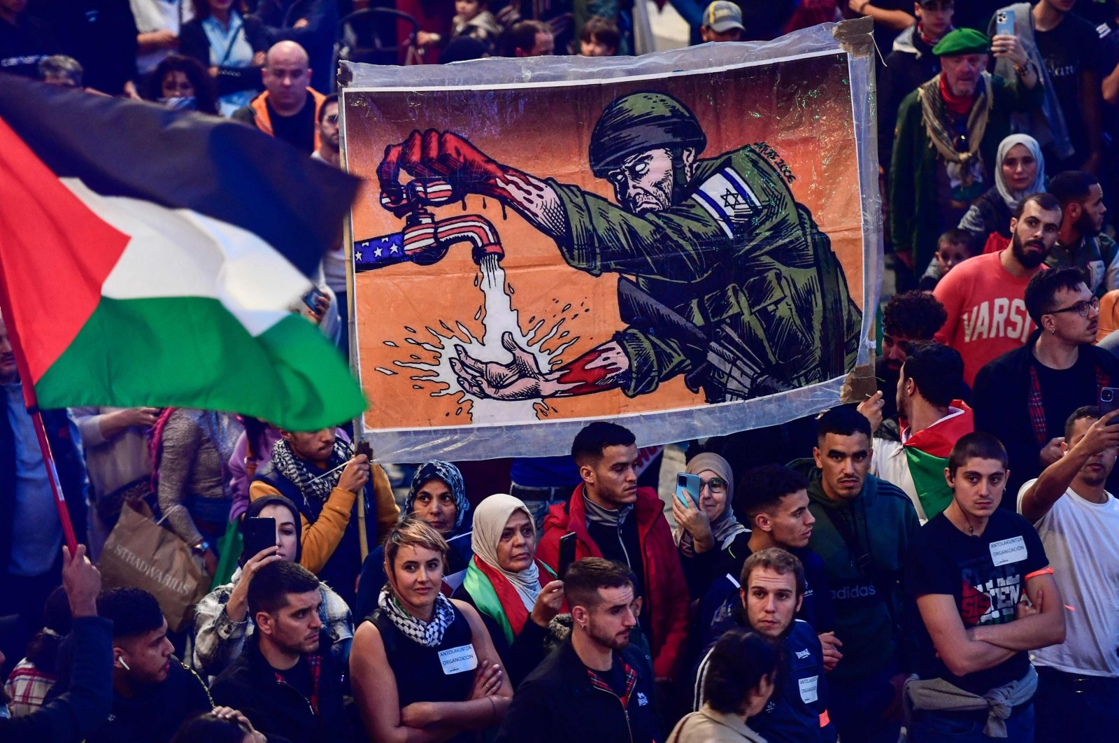 Demonstrators wave Palestinian flags and hold signs as they take part in a rally with slogan "Long live the Palestinian resistance. Genocidal Zionism", in support of the Palestinian people, in Bilbao, Spain, Oct. 28, 2023. (AFP Photo)