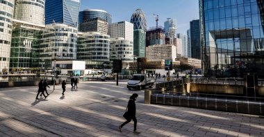 People walk in Paris' business district of la Defense, outside Paris, France, March 23, 2021. (AFP Photo)
