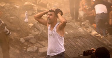 A Palestinian man reacts as others check the rubble of a building in Khan Younis, Gaza, Palestine, Nov. 6, 2023. (AFP Photo)