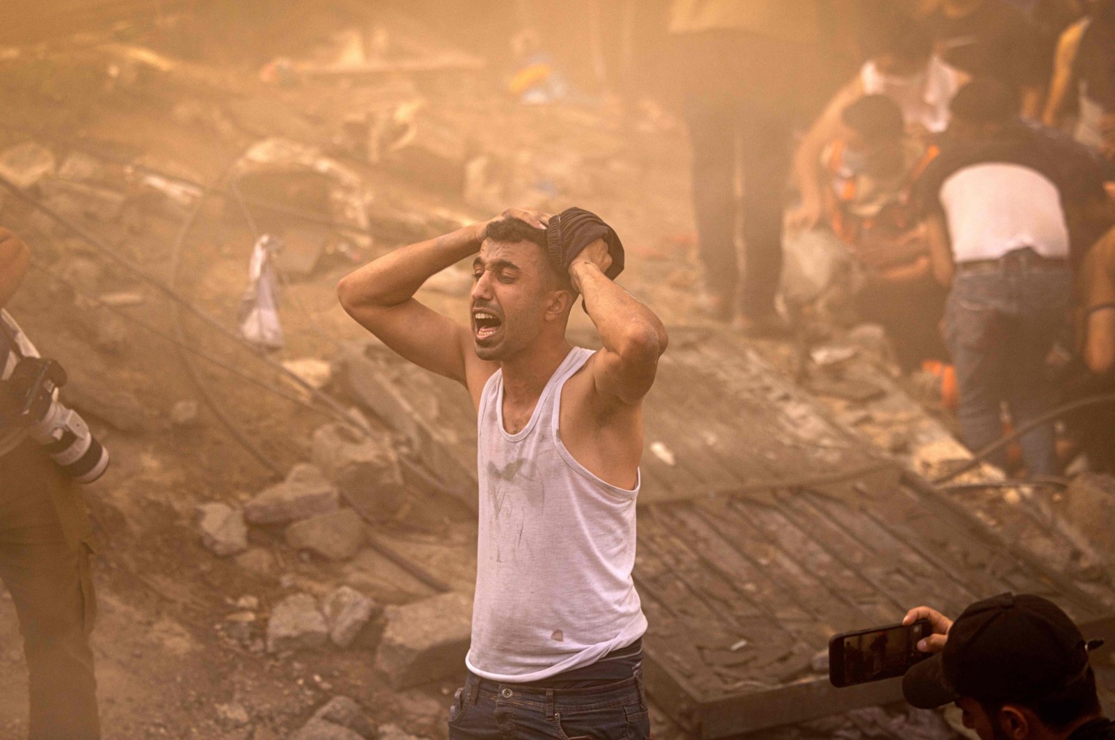 A Palestinian man reacts as others check the rubble of a building in Khan Younis, Gaza, Palestine, Nov. 6, 2023. (AFP Photo)