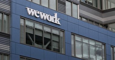 The WeWork logo is displayed outside of a shared commercial office space building in Los Angeles, California, U.S., Aug. 8, 2023. (AFP Photo)