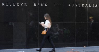 A woman walks past the outside of the Reserve Bank of Australia, in Sydney, Australia, May 3, 2022. (AP Photo)