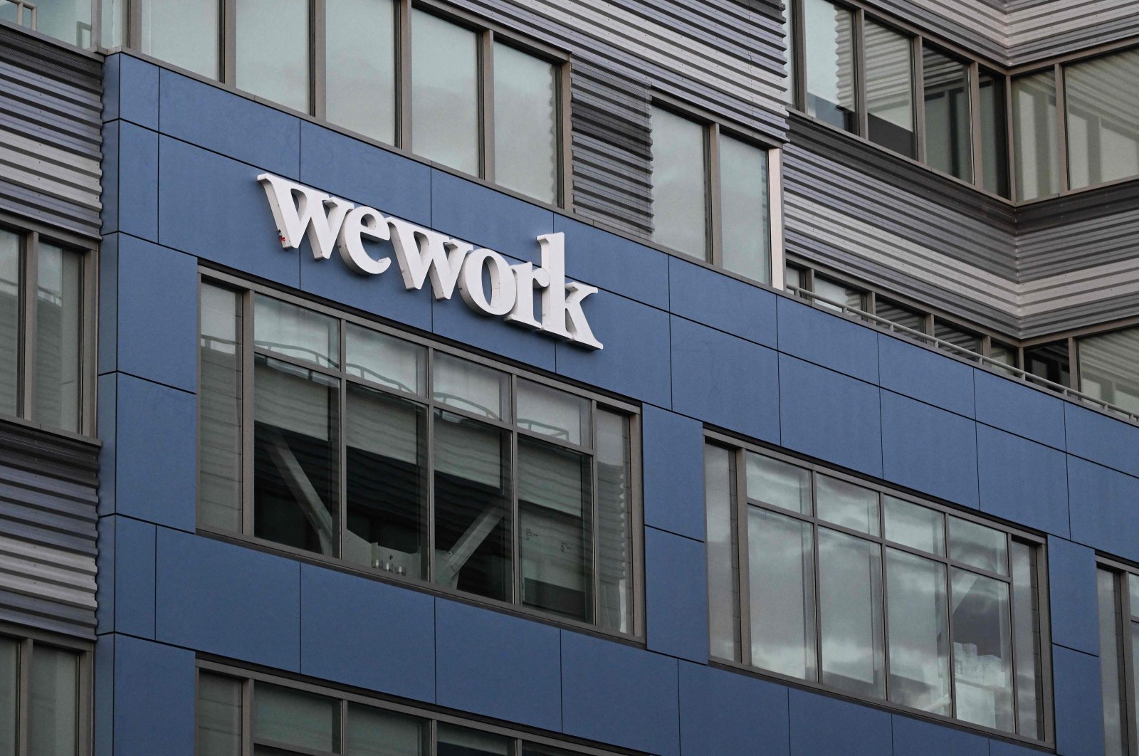 The WeWork logo is displayed outside of a shared commercial office space building in Los Angeles, California, U.S., Aug. 8, 2023. (AFP Photo)