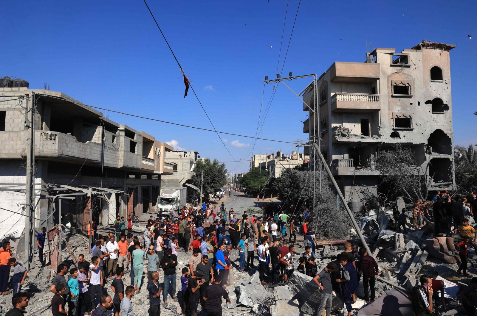 Palestinians gather at the site of collapsed and damaged buildings following an Israeli airstrike in Rafah, in the southern Gaza Strip, Palestine, Oct. 16, 2023. (AFP Photo)
