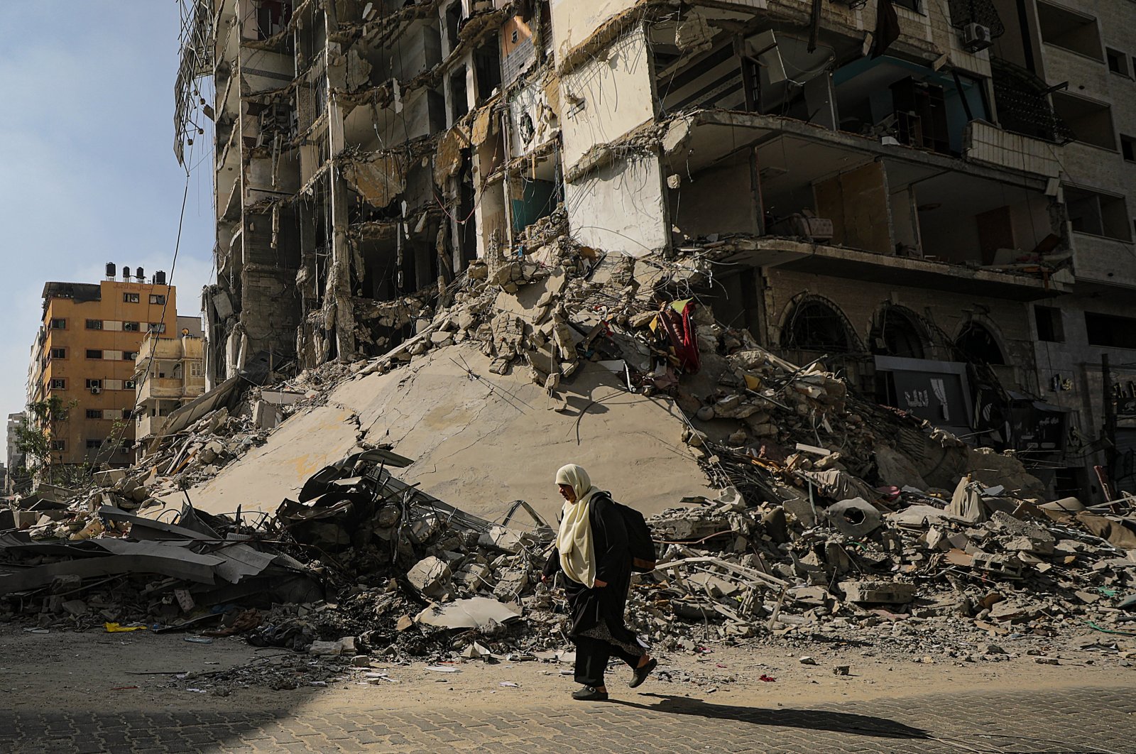 A woman walks past destroyed buildings as she evacuates Gaza City amid increased Israeli military operations in the Gaza Strip, Palestine, Nov. 8, 2023. (EPA Photo)