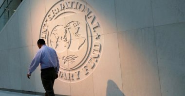 A man walks past the International Monetary Fund (IMF) logo at its headquarters in Washington, U.S., May 10, 2018. (Reuters Photo) 