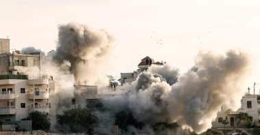 Smoke billows as two Palestinian homes are blown up by Israel. At least 170 Palestinians and three Israelis have been killed in the occupied West Bank since Oct. 7, Hebron, Palestine, Nov. 10, 2023. (AFP Photo).