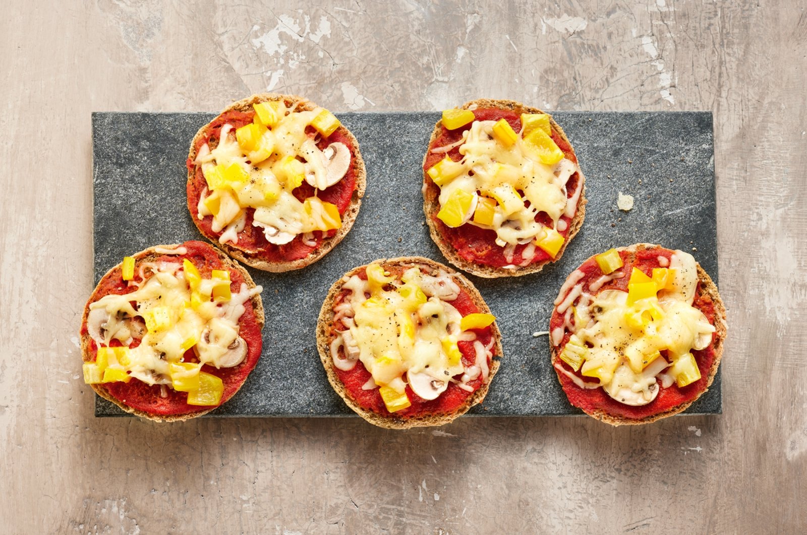 As quick to prepare as a frozen pizza: halved soft bread rolls that can be toasted are also great as the base of mini pizzas. (dpa Photo)