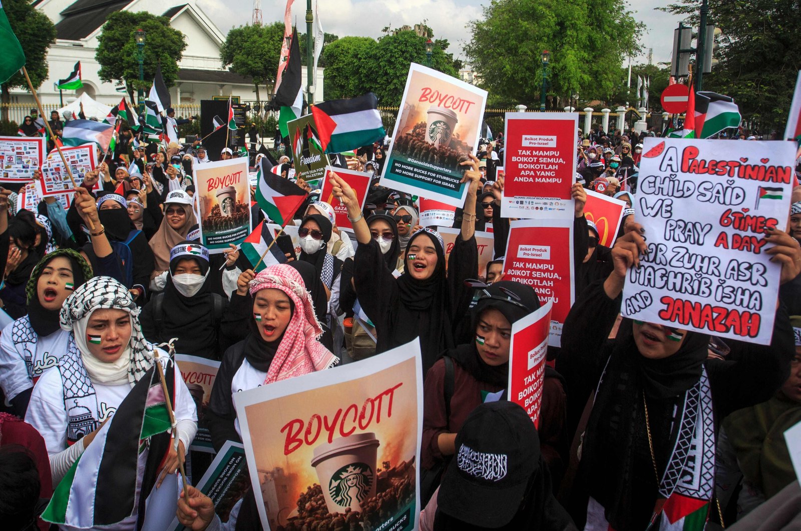 Demonstrators hold placards calling for the boycott of pro-Israel products and companies during a protest to show their solidarity with the Palestinian people in Yogyakarta, Indonesia, Nov. 11, 2023. (AFP Photo)