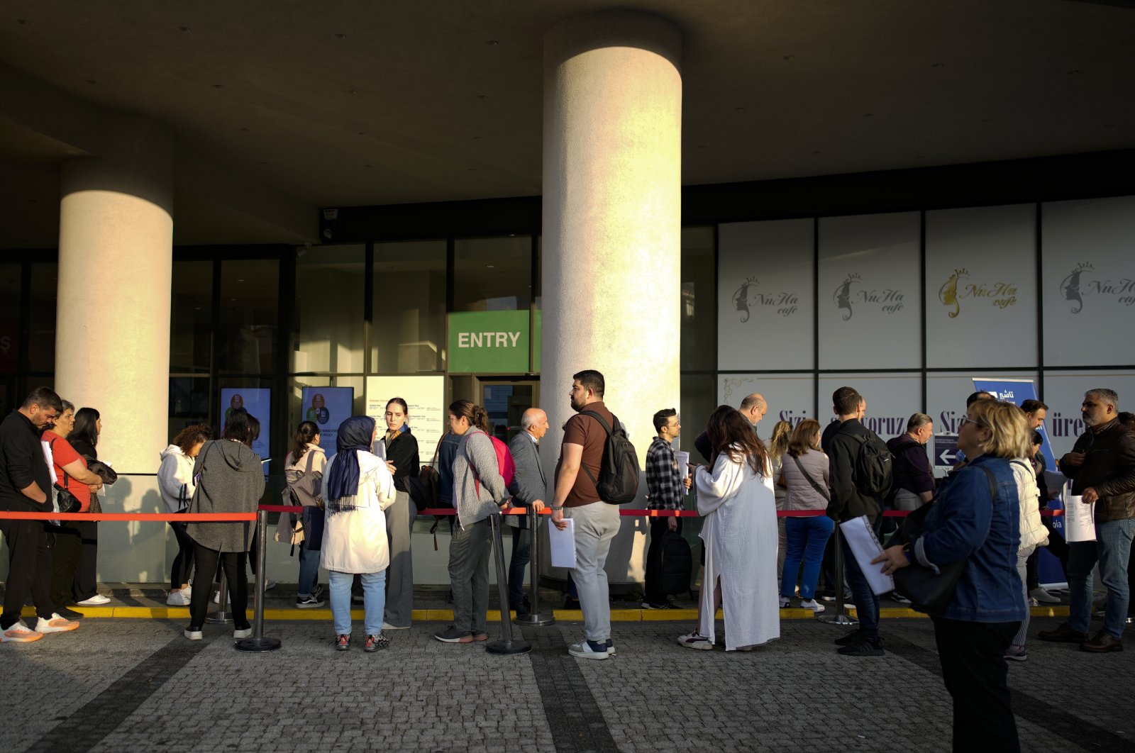 People wait for their turn at a visa application center, Istanbul, Türkiye, Nov. 3, 2023. (AP Photo)