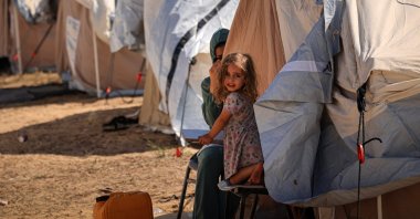 A little girl sits among tents set up for Palestinians seeking refuge on the grounds of a UNRWA center in Khan Yunis, in the southern Gaza Strip, Palestine, Oct. 19, 2023. (AFP Photo)