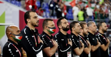 Palestine's coaching team stand during the national anthems before the match against Jordan at the Ras Abu Aboud Stadium, Doha, Qatar, Dec. 7, 2021. (Reuters Photo)