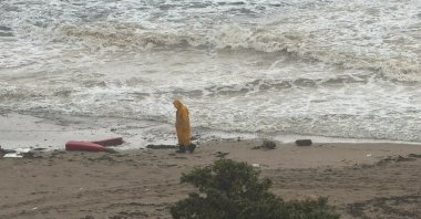 The Turkish coast guard inspects the wreckage of a migrant ship that capsized in the Aegean Sea, as crews search for two missing people off the coast of western Izmir province, Türkiye, Nov. 13, 2023. (AA Photo)