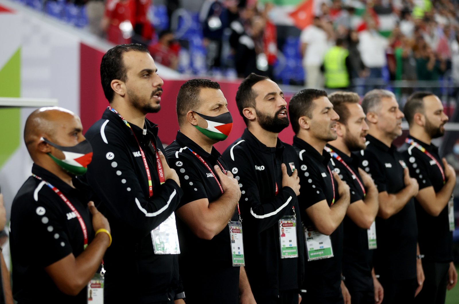 Palestine&#039;s coaching team stand during the national anthems before the match against Jordan at the Ras Abu Aboud Stadium, Doha, Qatar, Dec. 7, 2021. (Reuters Photo)