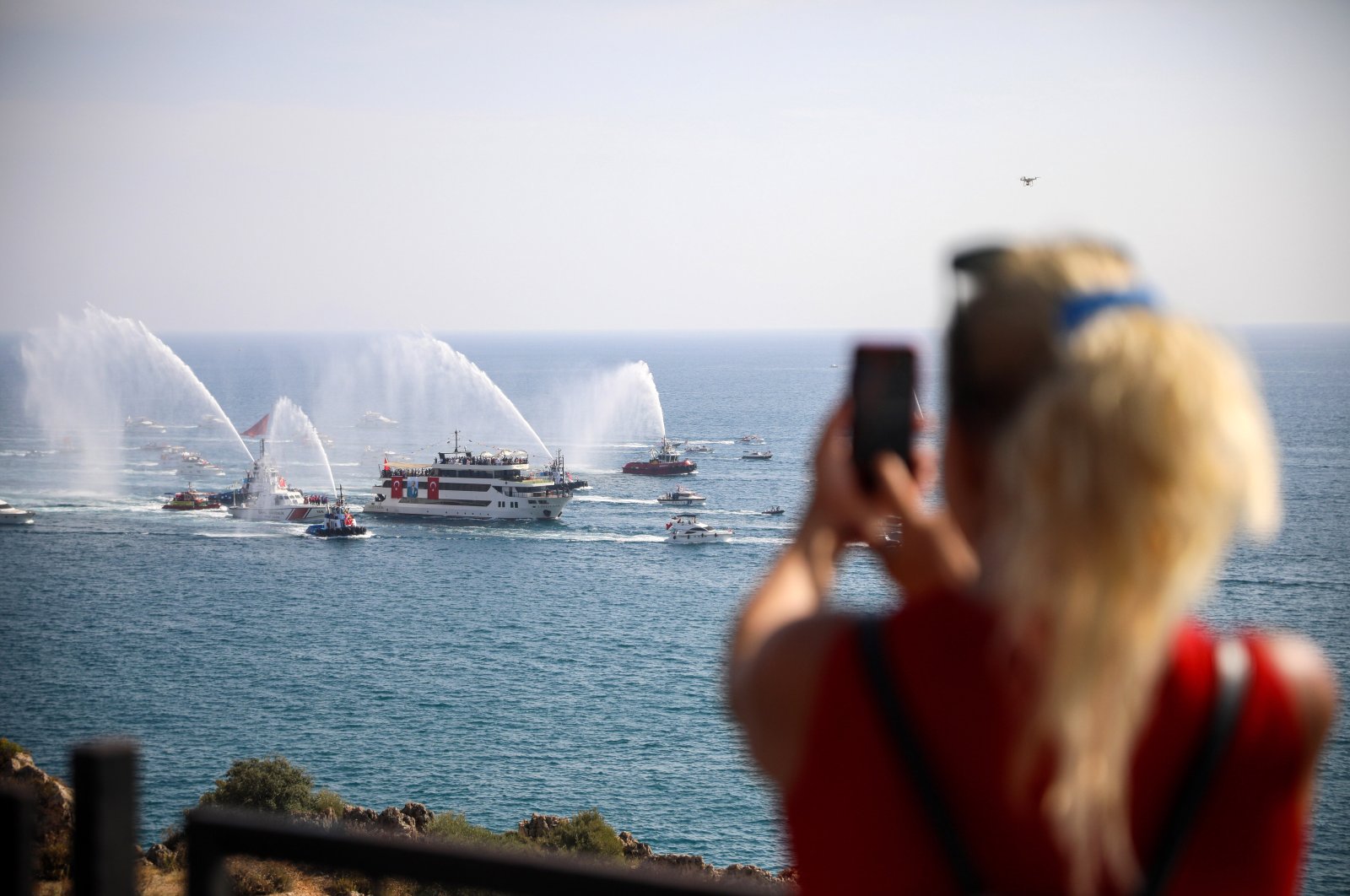 A tourist is seen clicking a photo while observing celebrations ahead of Republic Day, Antalya, southern Türkiye, Oct. 28, 2023. (DHA Photo)