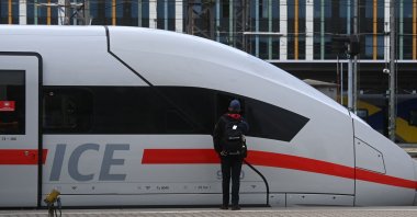 An employee of German railway operator Deutsche Bahn (DB) stands next to an ICE high-speed train during a strike called by the German train drivers union (GDL) at the main railway station in Munich, southern Germany, on Aug. 23, 2021. (AFP Photo)