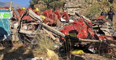 Men gather near the wrecked bus in Doda, Kashmir, India, Nov. 15, 2023. (AFP Photo)